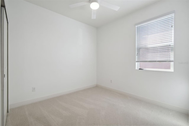 carpeted empty room with ceiling fan