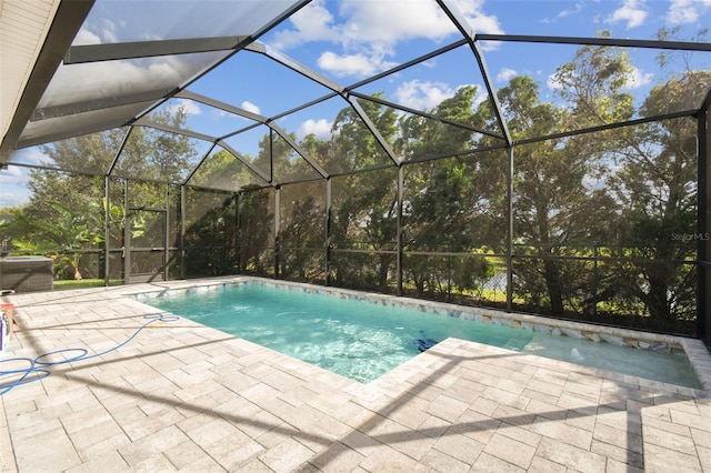 view of swimming pool with a lanai and a patio area