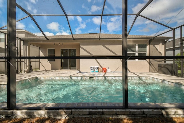 view of swimming pool with a lanai and a patio