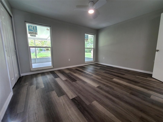 spare room with dark hardwood / wood-style floors and ceiling fan