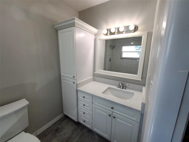 bathroom featuring walk in shower, vanity, hardwood / wood-style flooring, and toilet