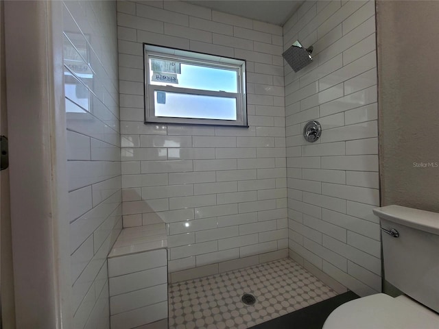 bathroom with toilet and tiled shower