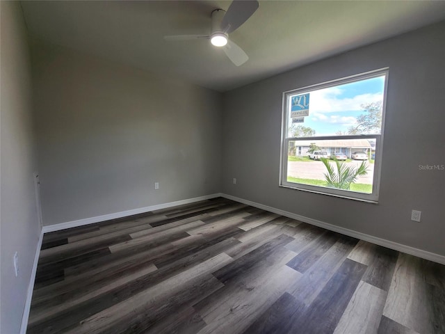 empty room with dark wood-type flooring and ceiling fan