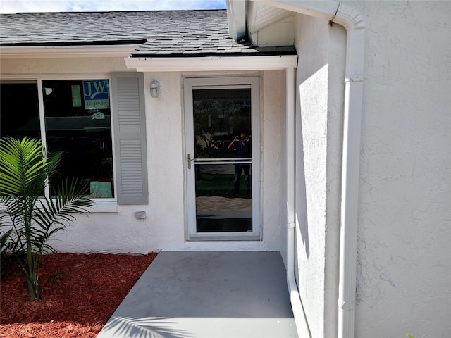 entrance to property featuring a patio