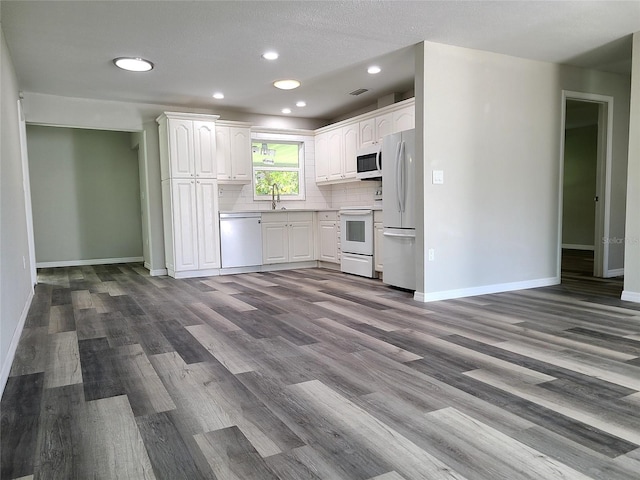 kitchen with white cabinetry, light wood-type flooring, a textured ceiling, sink, and white appliances