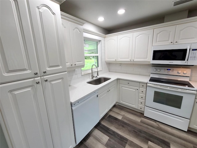 kitchen featuring sink, tasteful backsplash, dark hardwood / wood-style floors, white appliances, and white cabinets