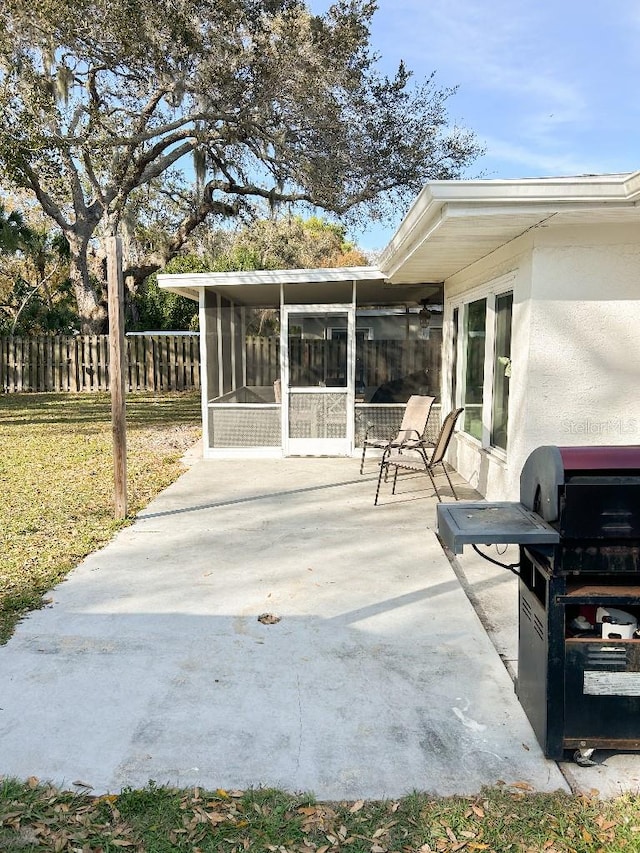 view of patio / terrace with area for grilling and a sunroom