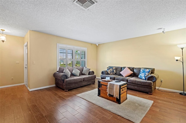 living room featuring hardwood / wood-style floors and a textured ceiling