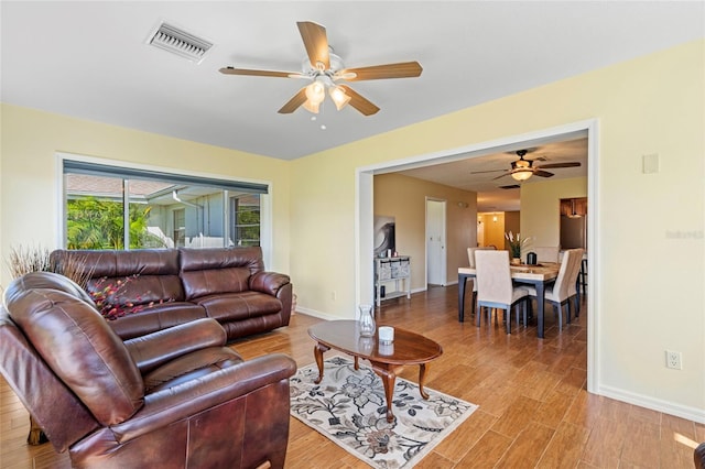 living room featuring ceiling fan and light wood-type flooring