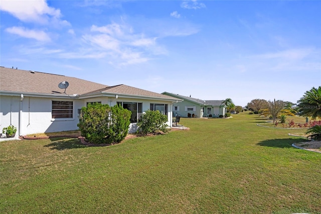 rear view of property with a lawn