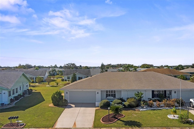 ranch-style house featuring a front yard and a garage