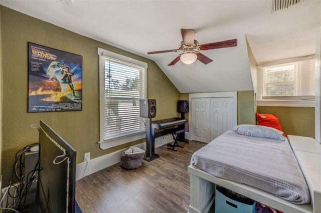 bedroom featuring a closet, wood-type flooring, vaulted ceiling, and ceiling fan