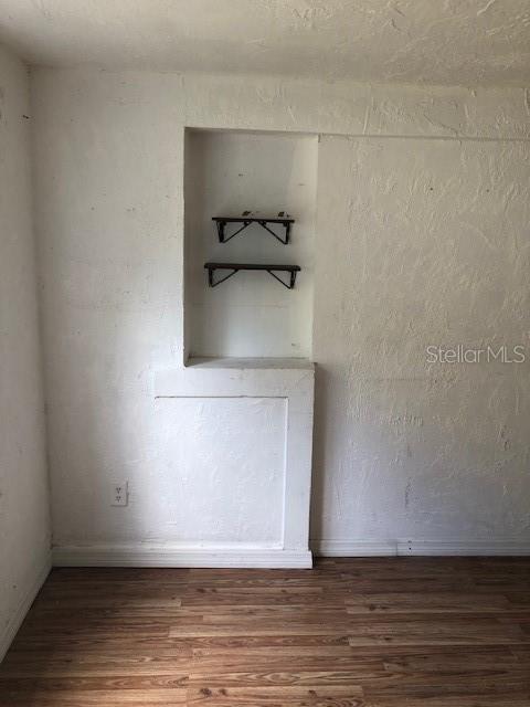 empty room featuring dark wood-type flooring