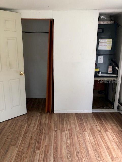 unfurnished bedroom with wood-type flooring