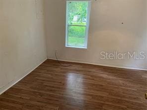 spare room with wood finished floors