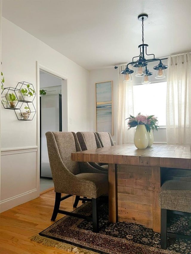 dining room featuring an inviting chandelier and hardwood / wood-style floors