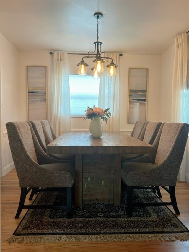 dining room with a chandelier and light wood-type flooring