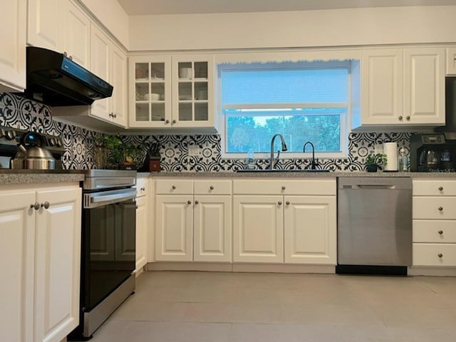 kitchen with white cabinetry, backsplash, stainless steel appliances, and sink