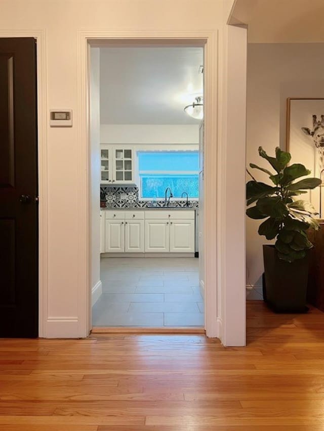 hallway featuring sink and light wood-type flooring