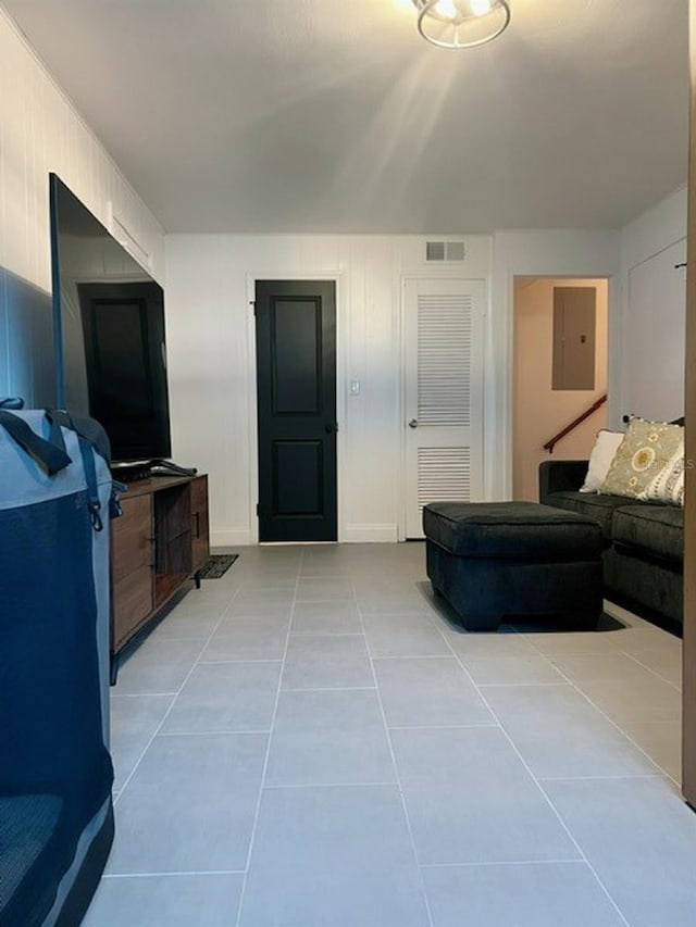 tiled living room with electric panel