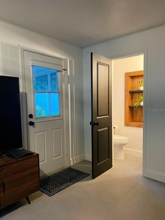 doorway with light tile patterned flooring