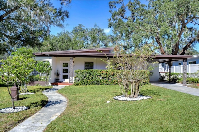 1802 E Hamilton Ave, Tampa, FL 33610 - view of front of home featuring a carport, stucco siding, and driveway