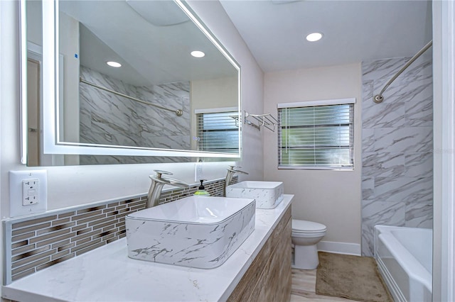1802 E Hamilton Ave, Tampa, FL 33610 - full bathroom with double vanity, shower / bathtub combination, recessed lighting, and tasteful backsplash