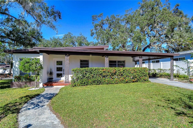 1802 E Hamilton Ave, Tampa, FL 33610 - view of front of house featuring stucco siding, a carport, and concrete driveway