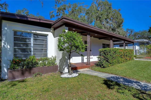 1802 E Hamilton Ave, Tampa, FL 33610 - view of front of home featuring a front yard, stucco siding, and a porch