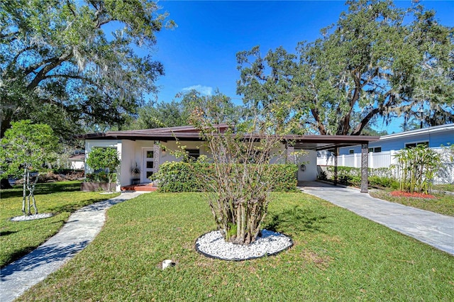 1802 E Hamilton Ave, Tampa, FL 33610 - view of front of house with concrete driveway, stucco siding, and an attached carport