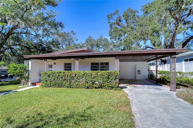 1802 E Hamilton Ave, Tampa, FL 33610 - view of front of house with driveway, a carport, and stucco siding