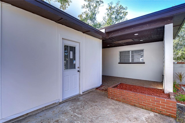 1802 E Hamilton Ave, Tampa, FL 33610 - property entrance with a patio and stucco siding