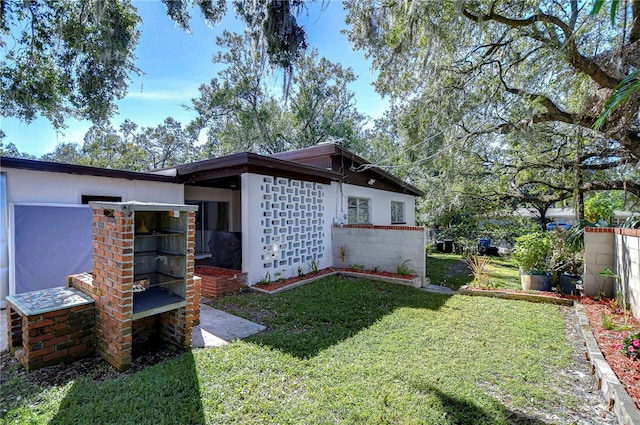 1802 E Hamilton Ave, Tampa, FL 33610 - view of home's exterior featuring a yard and stucco siding