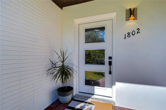 1802 E Hamilton Ave, Tampa, FL 33610 - doorway to property with stucco siding