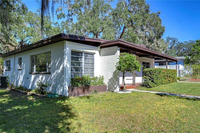 1802 E Hamilton Ave, Tampa, FL 33610 - view of front of property featuring a front yard and stucco siding