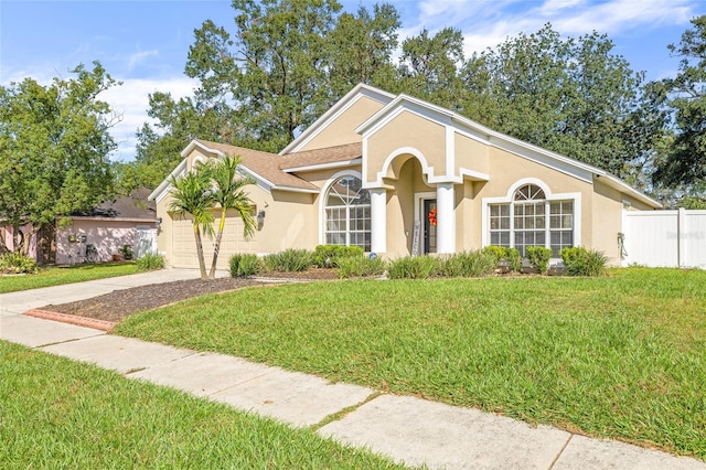 view of front of home featuring a front yard and a garage