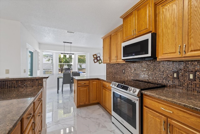 kitchen with stainless steel range with electric cooktop, backsplash, a textured ceiling, hanging light fixtures, and dark stone countertops