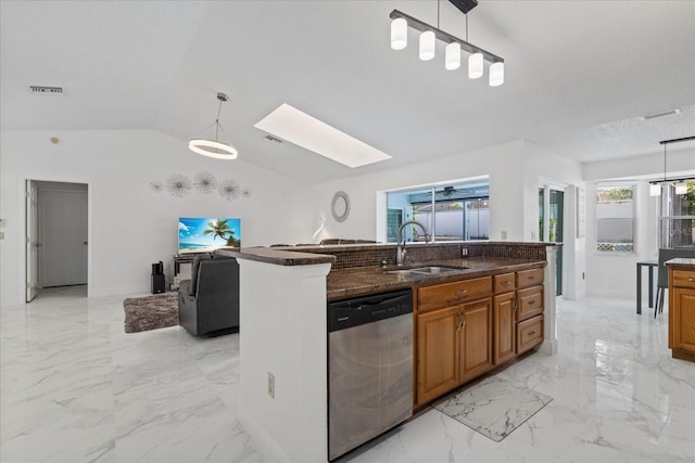 kitchen with stainless steel dishwasher, lofted ceiling with skylight, sink, and hanging light fixtures