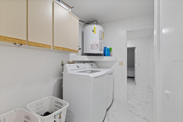 laundry room featuring cabinets, water heater, and washer and dryer