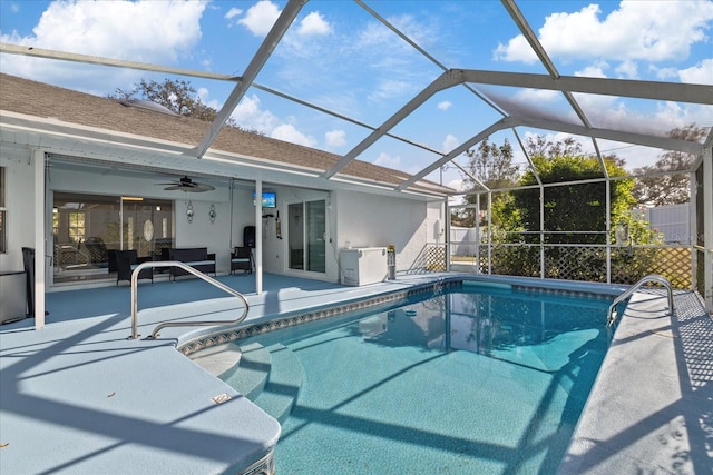 view of pool featuring ceiling fan, a lanai, and a patio area