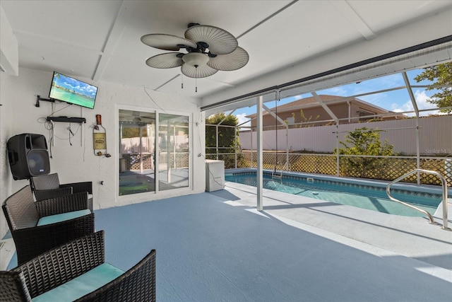 view of swimming pool featuring a patio, a lanai, and ceiling fan