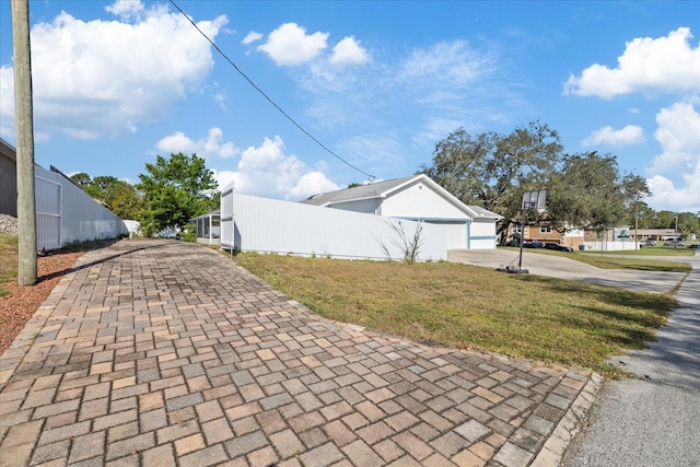 view of side of home with a yard and a garage