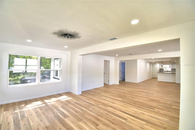 unfurnished living room with light wood-type flooring