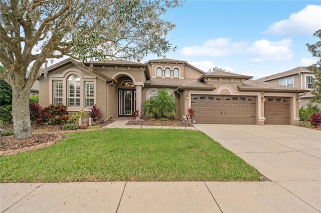 view of front of property featuring a front yard and a garage