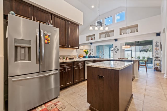 kitchen with high vaulted ceiling, stainless steel appliances, dark brown cabinetry, and hanging light fixtures