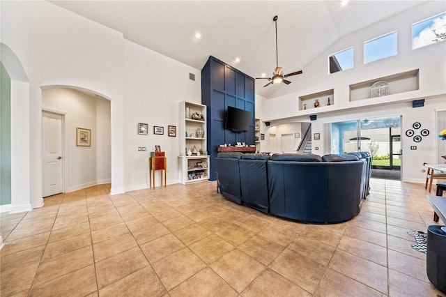 living room featuring high vaulted ceiling, light tile patterned floors, built in features, and ceiling fan