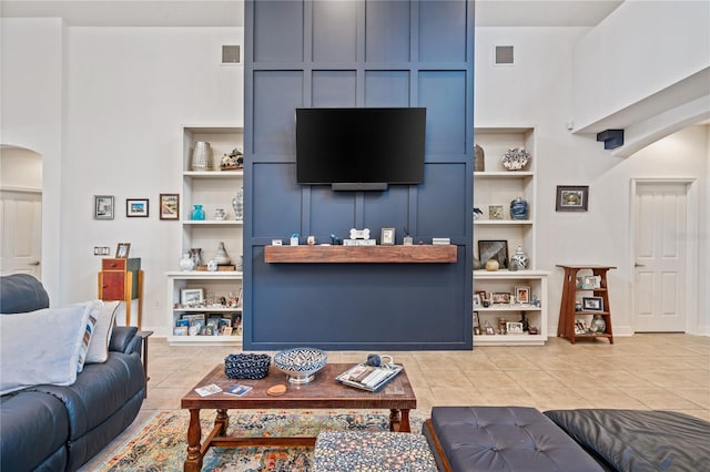 living room with light tile patterned flooring and built in features