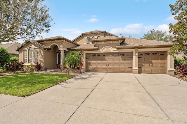 view of front of property with a front yard and a garage