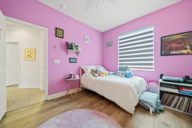 bedroom with wood-type flooring and ceiling fan