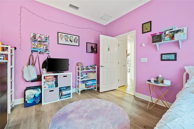 bedroom with hardwood / wood-style floors